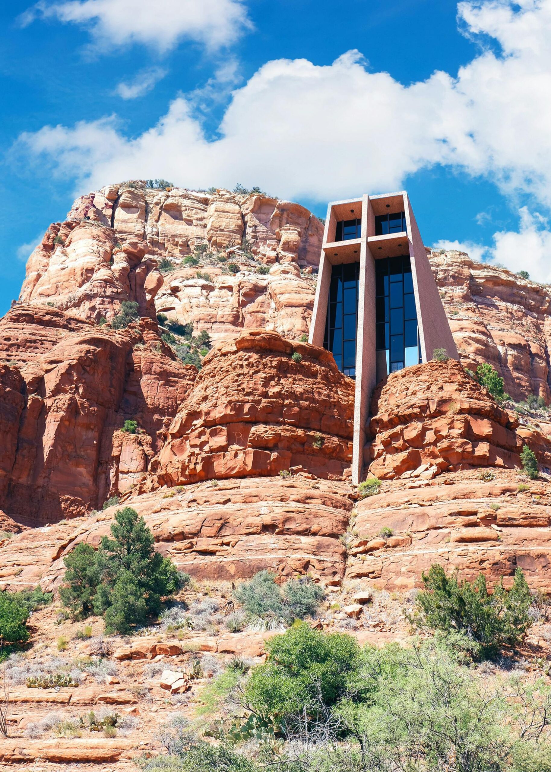 Iconic Chapel of the Holy Cross amidst Sedona's red rock formations under a vibrant blue sky.