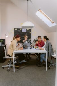 Diverse team collaborating in a stylish office setting, fostering innovation and teamwork.